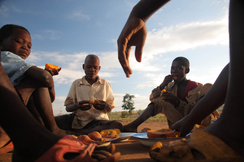 Mozambique Gurue eat freshly prepared OFSP
