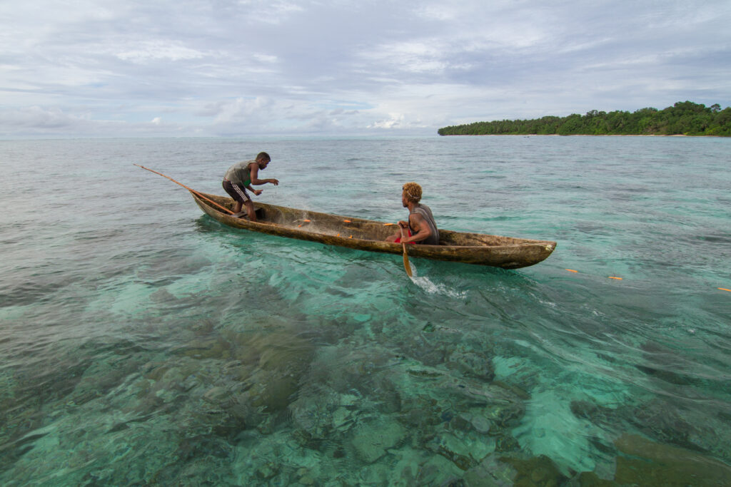 Two fisherman put out a net to catch reef fish Fumatoo Malaita Province Solomon Islands